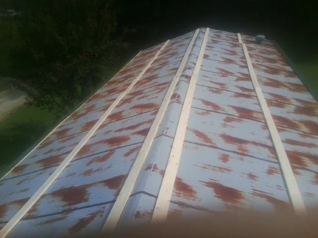 Rusted metal roof panels with new wood purlins before replacement — Storm Damage Roof Repair in Tullahoma by Roofing Brothers